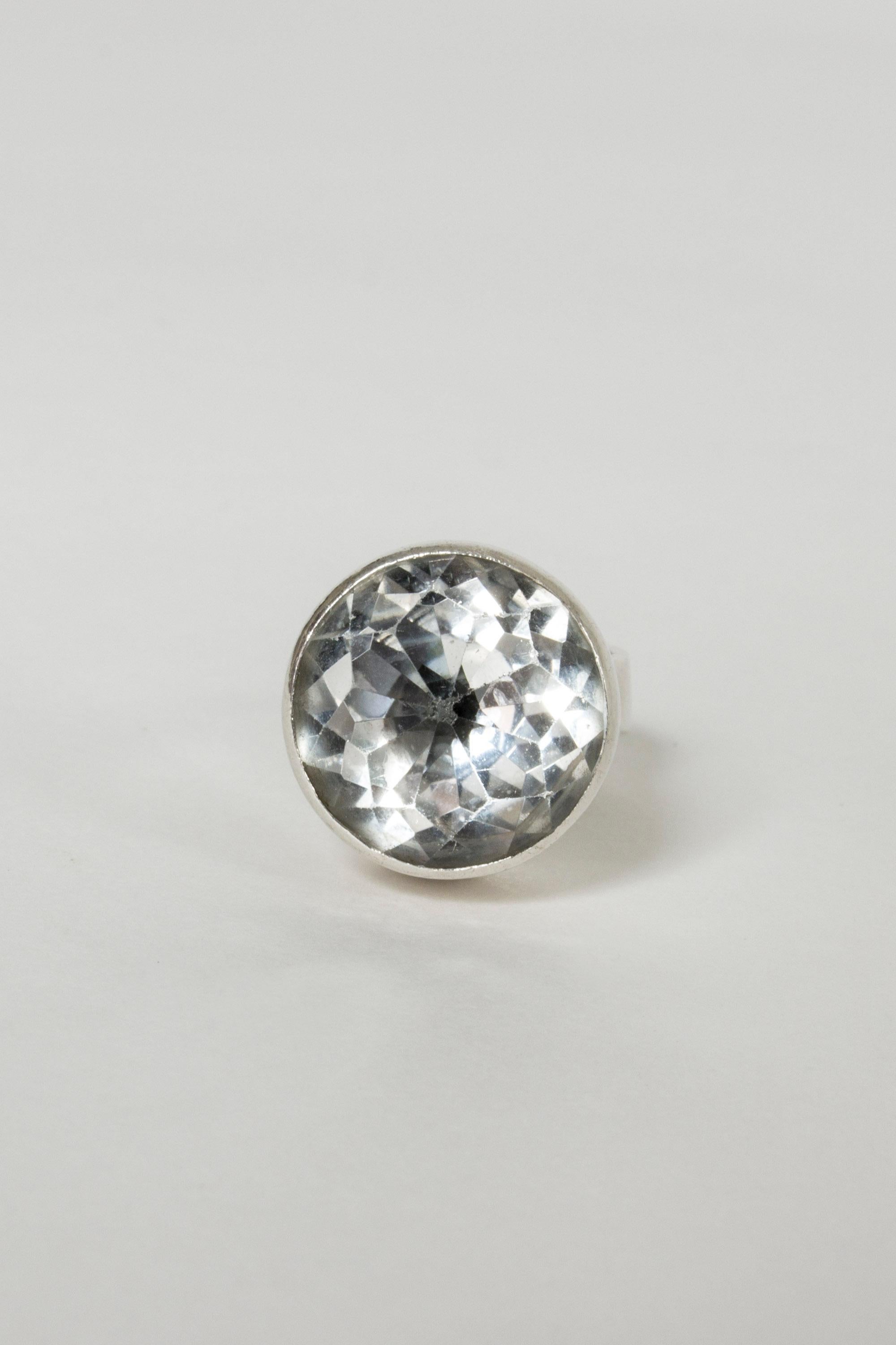 Cool silver ring by Isaac Cohen, with a large rock crystal stone. Clean design with nice play between the sparkly stone and smooth silver cylinder setting.