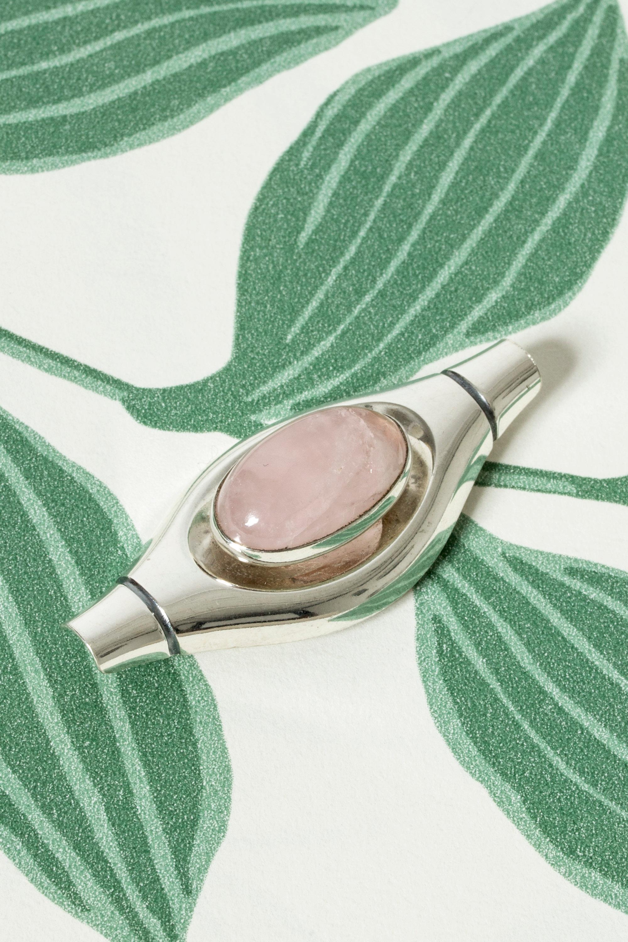 Lovely silver brooch by Elis Kauppi, in an appealing imaginative form with an oval rose quartz stone in the center. Beautiful, crisp pink color.