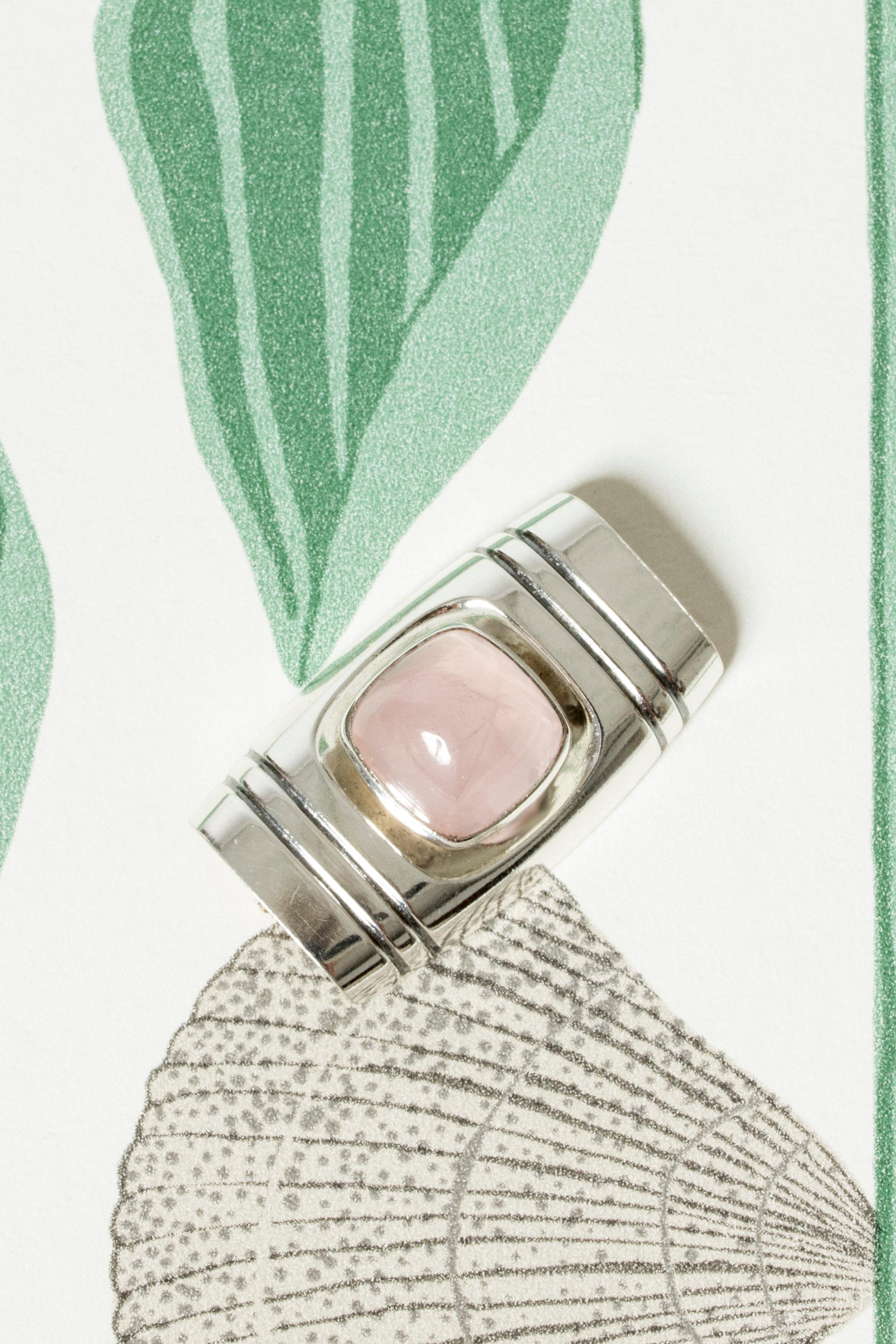 Lovely silver brooch by Elis Kauppi, in a rectangular form with a large rose quartz stone in the center. Beautiful, crisp pink color.