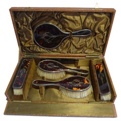 Silver and silver pique tortoiseshell hairbrushes and hand mirror original case