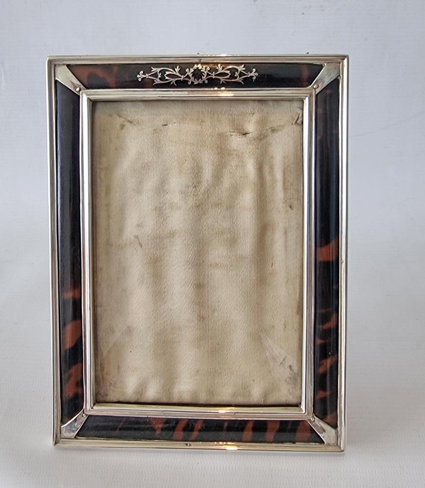 A fine silver pique work and tortoiseshell inlaid photo frame by Henry Matthews. Silver hall marks for Henry Matthews, Birmingham, 1916. With silver, hallmarked strut backing.