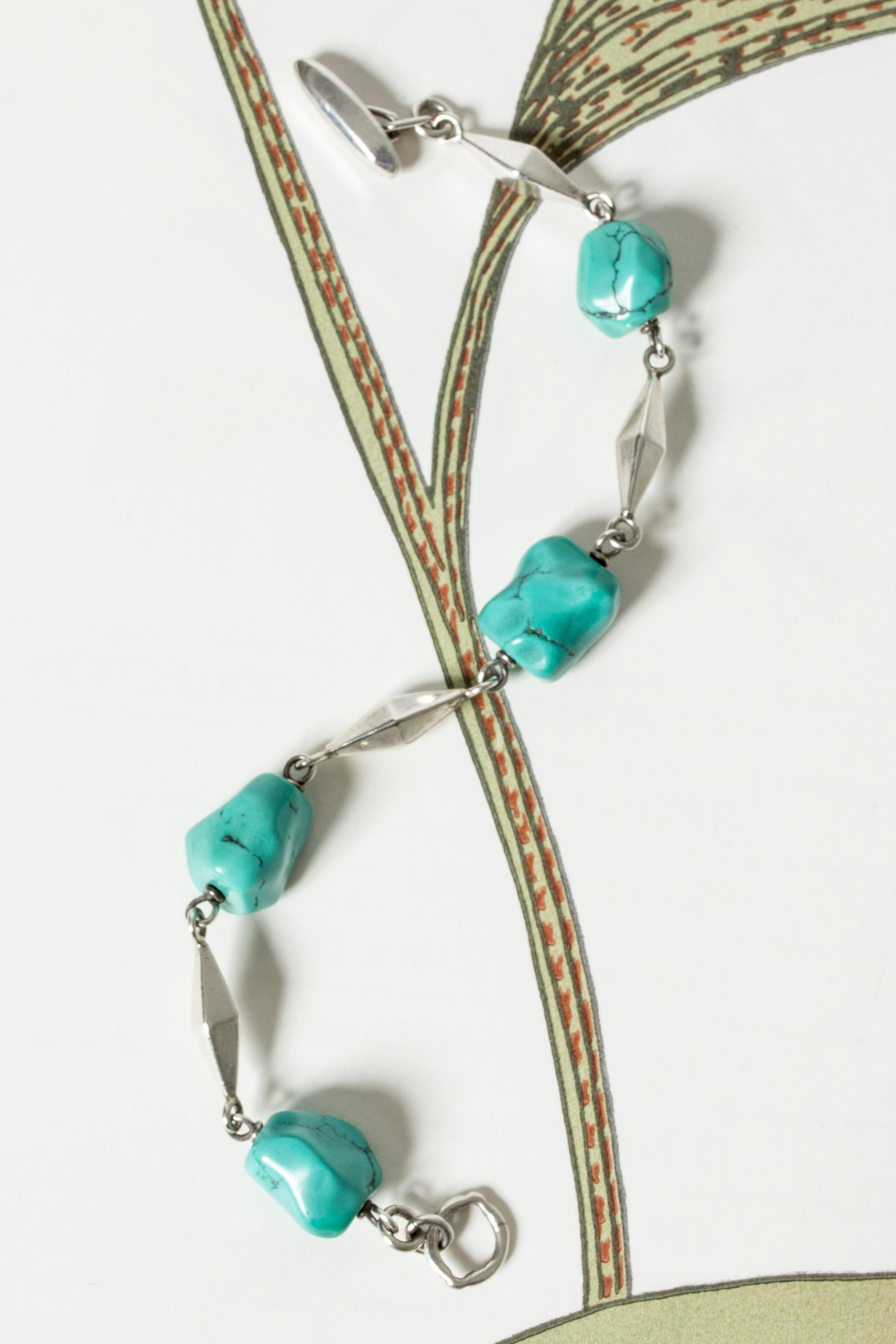 Beautiful, summery silver bracelet by Arvo Saarela, with chunky, tumbled turquoise stones, alternating with silver diamond shaped sections. Elegant and colorful, perfect for bronzed skin.