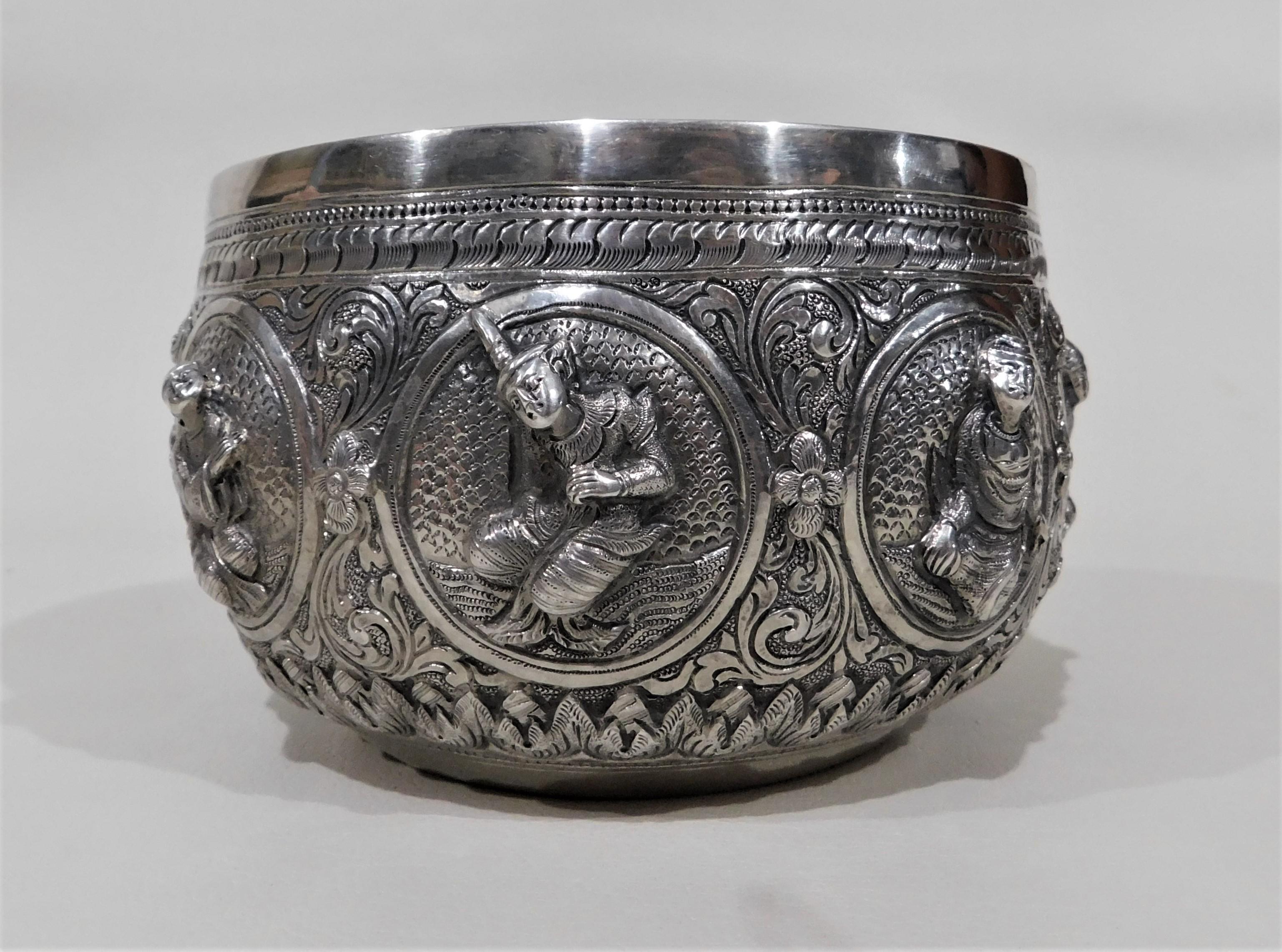 Handmade silver Anglo-Indian bowl with eight figures each featuring a different pose. Ornate engraved peacock on the bottom of bowl.