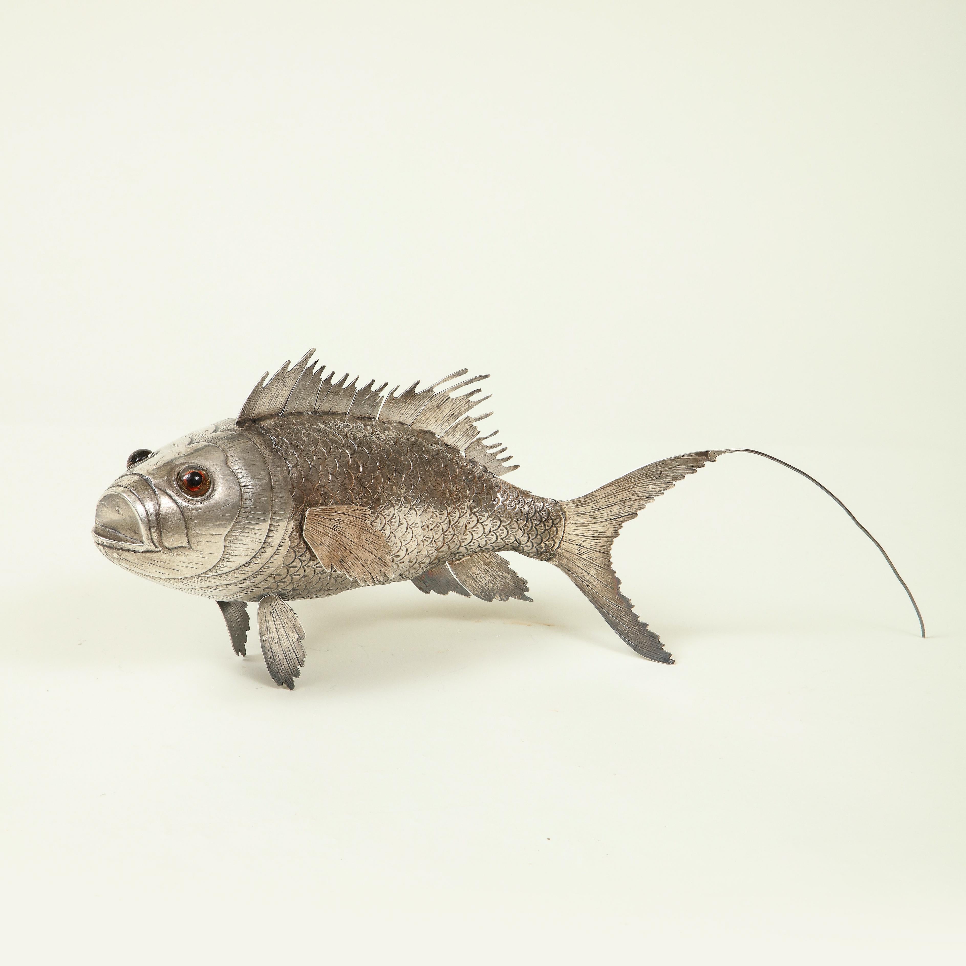 The head, with jeweled eyes, and the body realistically modeled with articulated sections allowing the body and the fins to move from side to side.

Provenance: From the Collection of Mario Buatta, New York, NY.