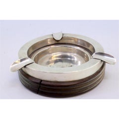 Silver ashtray on turned wood with three cigarette holders