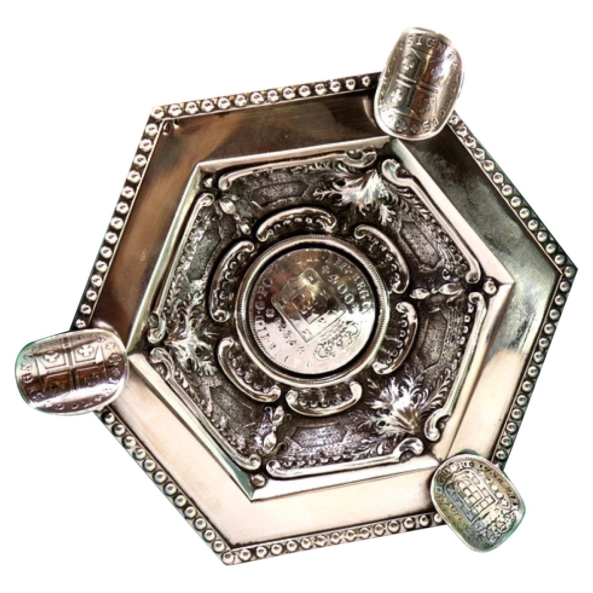 Silver ashtray w/ embossed pearly rim
coin applications as a cigarette holder