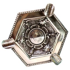 Silver ashtray w/ embossed pearly rim 
coin applications as a cigarette holder