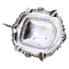 Silver ashtray with acanthus relief border, four rests, on tall applied feet