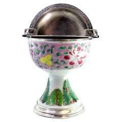 Silver ashtray with hinged lid and Chinese ceramic cup-form enamel insert Silver ashtray with hinged lid and Chinese ceramic cup-form enamel insert