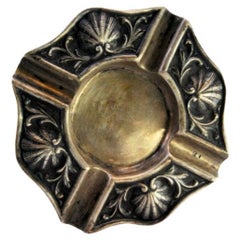 Silver ashtray with shell-shaped reliefs and four cigarette holders
