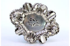 Silver ashtray with shells, reliefs, four rests, and Masonic symbol