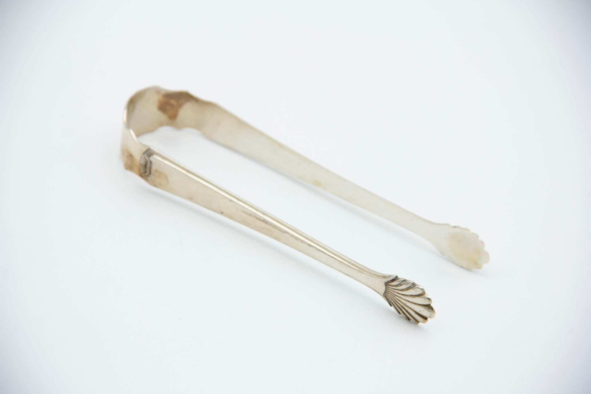 Silver asparagus or salad tongs with reliefs depicting asparagus