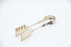 Silver asparagus or salad tongs with reliefs on the handle