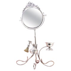 Silver barber hand mirror with perfumer, brush and cup