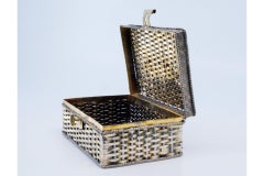 Silver basket in the shape of a box, bordered with ropes around it and a lock