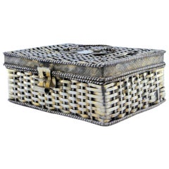 Silver basket in the shape of a box, bordered with ropes around it and a lock