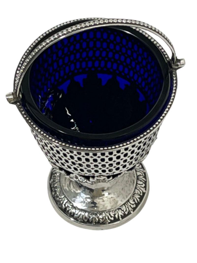 Silver basket with blue glass, by Richard Morton & Co, Sheffield, 1776

Silver basket on a round foot, openwork silver with acanthus leaves. The edge and the handle with pearl edge decorated. On the base and engraving of a crest (an arm with an ax