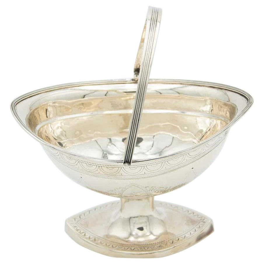 Silver basket with low reliefs on a high foot