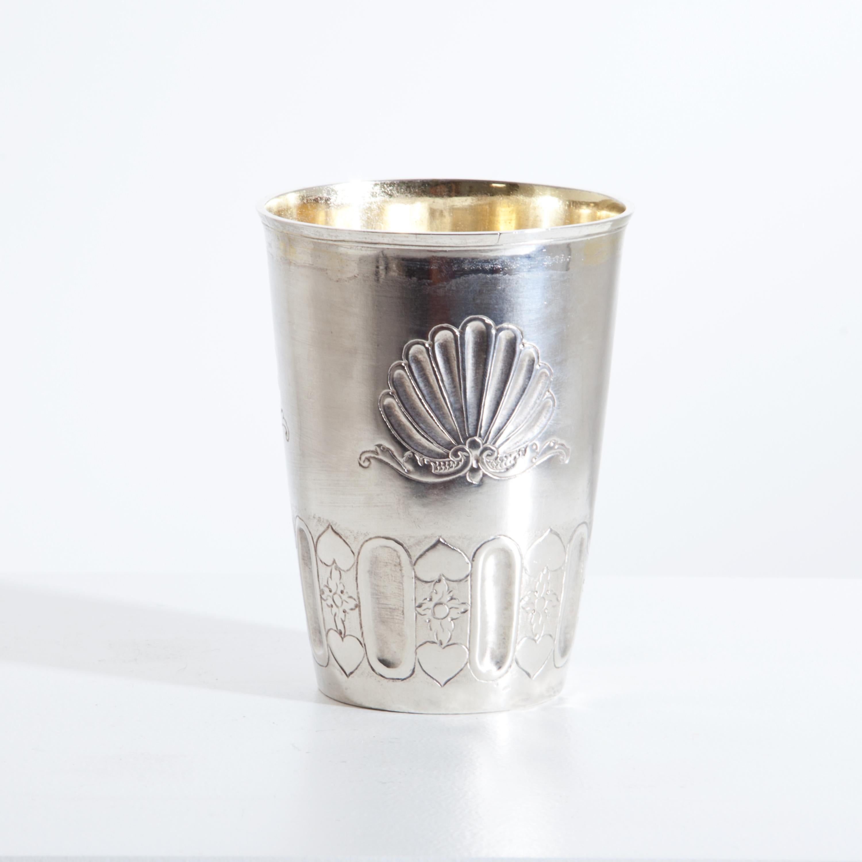 Large silver beaker with conical walls and shell decorations over a band of flutes alternating with heart and leaf decorations. Gold plated inside. Stamped Augsburg, Melchior Burtenbach (Purtenbach). Lit: Seling 2479.