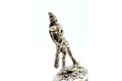 Silver bell w/ a barbarian warrior figure on a pedestal w/ reliefs & garlands