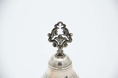 Silver bell with beaded reliefs and cut-out handle