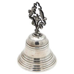Silver bell with beaded reliefs and cut-out handle