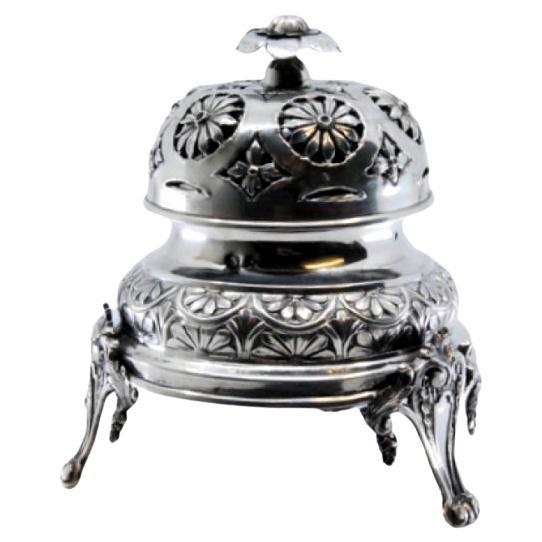 Silver bell with floral reliefs, mechanism inside and resting on four feet For Sale