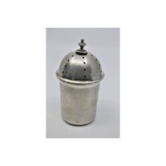 Silver bell with mechanism inside resting on a guilloche cup
