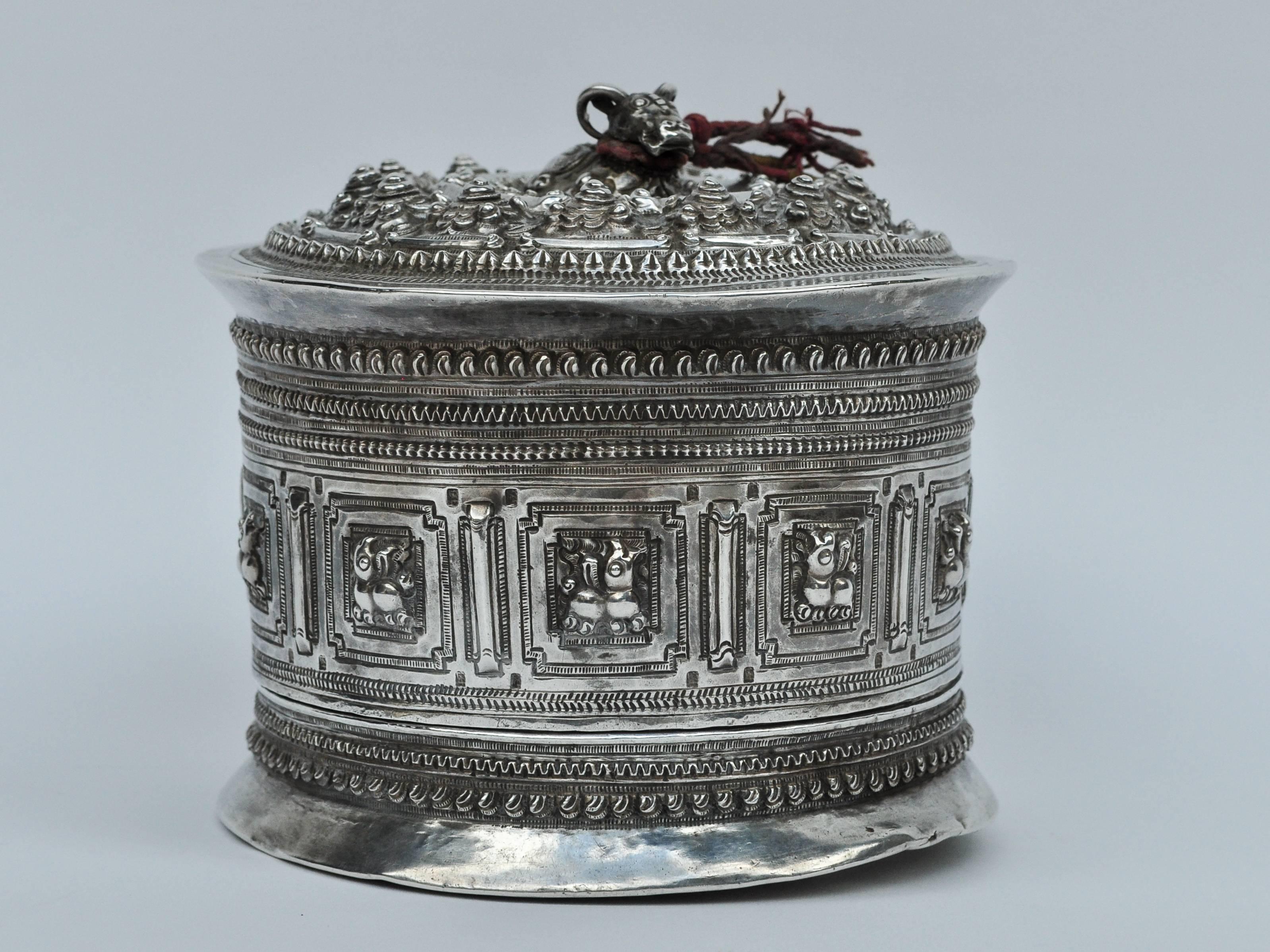 Silver betel box / Cannister from Laos. 19th century. Repousse work and chasing.
This finely worked container comprises a box, lid and inner tray and was used to keep and serve Betel, the areca nut, leaves and condiments. Betel chewing was an