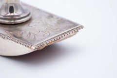 Silver blotter with engraved plant motifs, raised handle and surrounding frieze