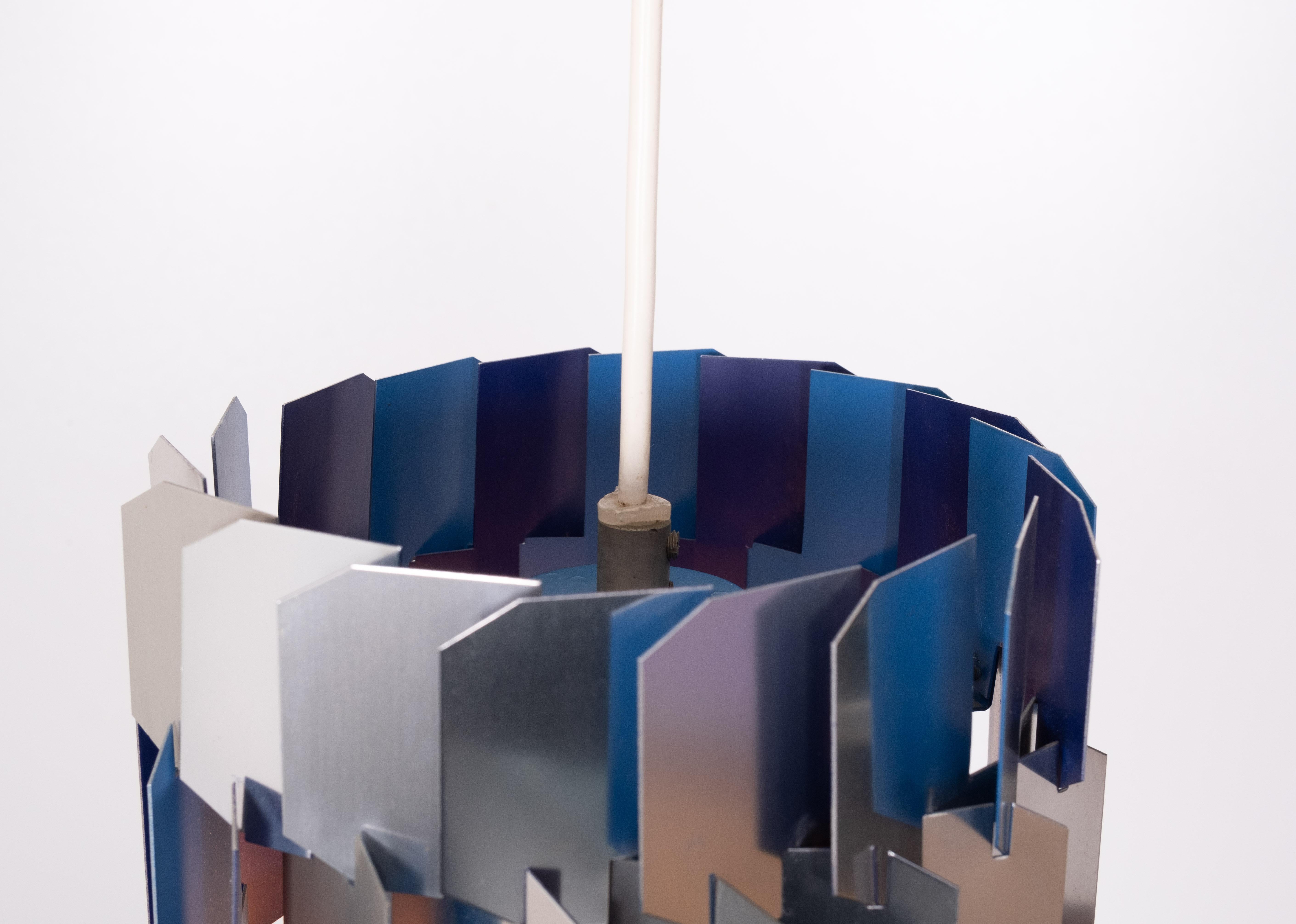 An iconic lamp designed by Louis Weisdorf for the Danish lamp manufacturer Lyfa. 1960s ,early version  .
The lamp is like a 3D puzzle, with eighteen identical metal elements, each a long punched and curved piece that fits into the next, and the