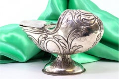 Silver boat w/ reliefs & applications, resting on a base w/ a monogram plaque