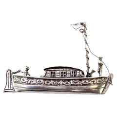 Silver boat with applications and relief figures