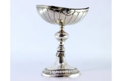 Silver boat with reliefs and applications, set on a round, engraved base