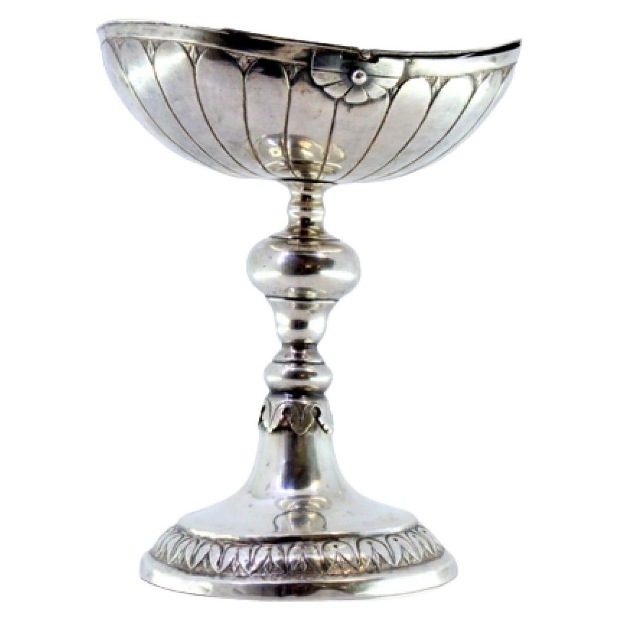 Silver boat with reliefs and applications, set on a round, engraved base