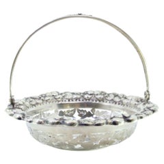 Silver bonbonniere basket w/ raised florals 
hinged handle