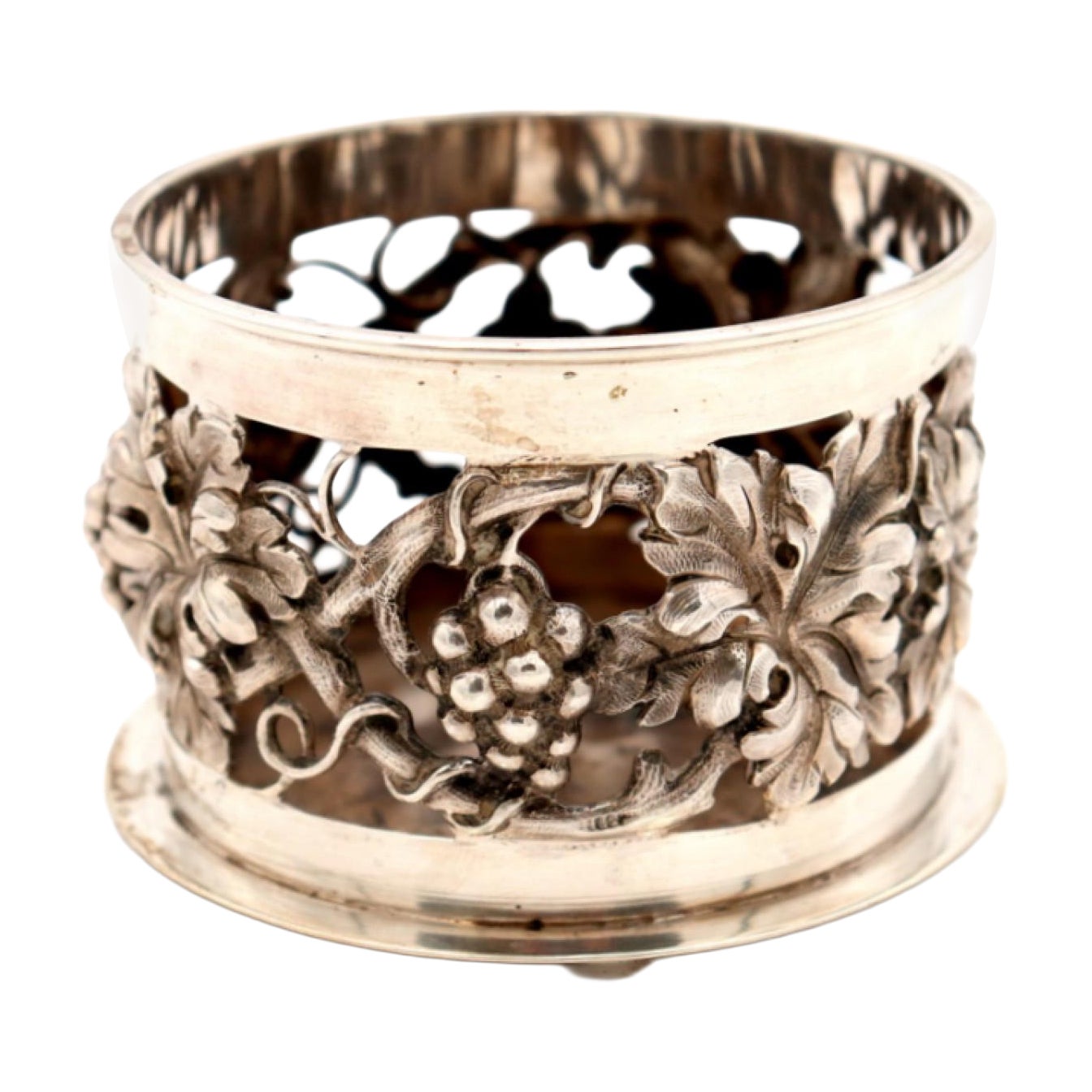 Silver bottle base with cut-out reliefs