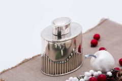 Silver bottle with elliptical fluted reliefs and removable lid