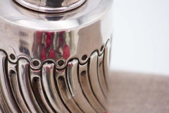Silver bottle with spiral reliefs and removable lid