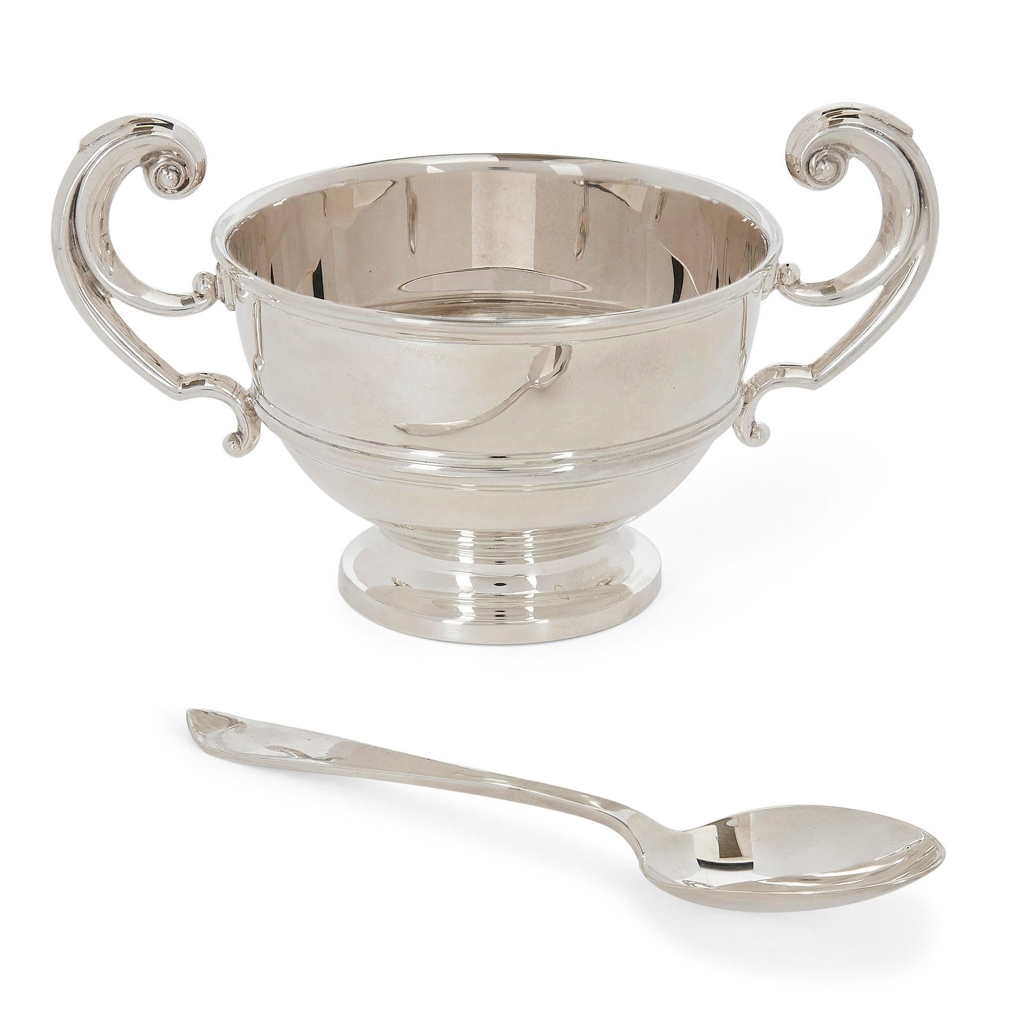 Silver bowl and spoon in fitted case by Irish firm West & Son
Irish, 1912
Measures: Bowl: Height 9cm, width 16cm, depth 10cm
Spoon: Length 15cm, width 3cm
Case: Height 11cm, width 17cm, depth 16cm

This fine trophy-like silver sugar bowl is by