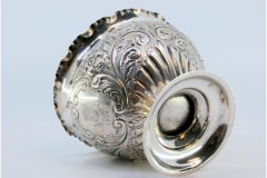Silver bowl with floral reliefs and a smooth round base