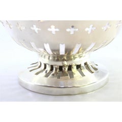Silver bowl with pearly cutouts and friezes, set on a circular base
