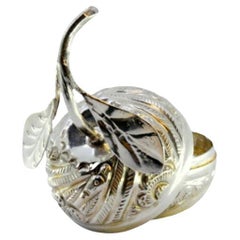 Silver box in the shape of a fruit with reliefs and leaf applications