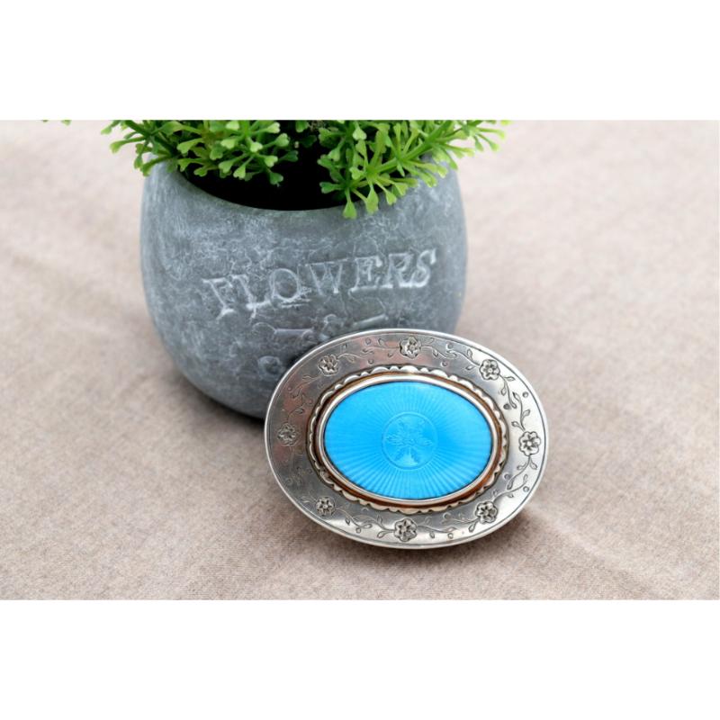 Description: Silver box with an elliptical shape and engraved floral motifs, framed enamel on the lid and gold interior. Metal: Silver. Origin: Portuguese. Brand: Eagle's Head. Weight: 97.67 grams. Dimensions: 7.5cmx6cm. Content: 833/1000. Assay