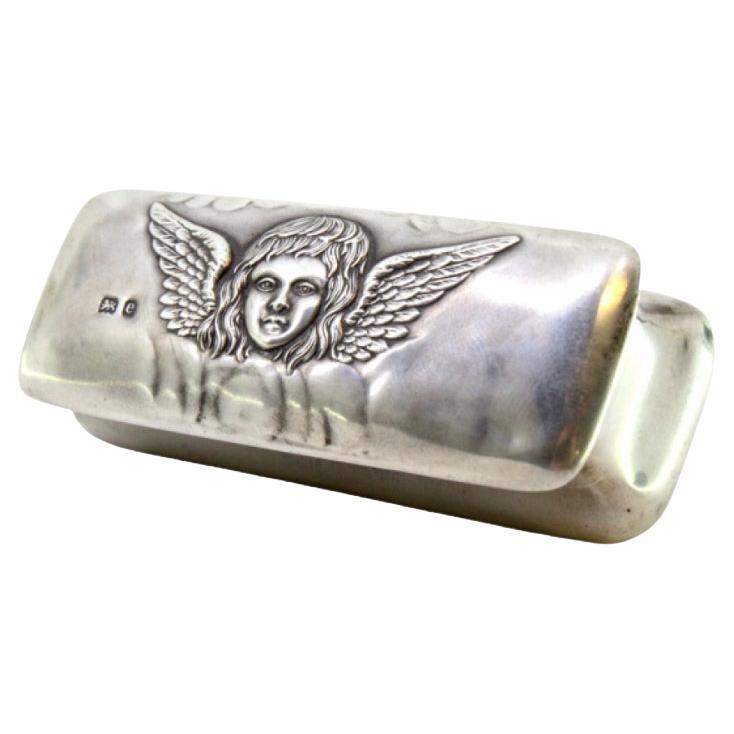Silver box w/ an angel embossed on the lid 
interior lined w/ purple velvet For Sale