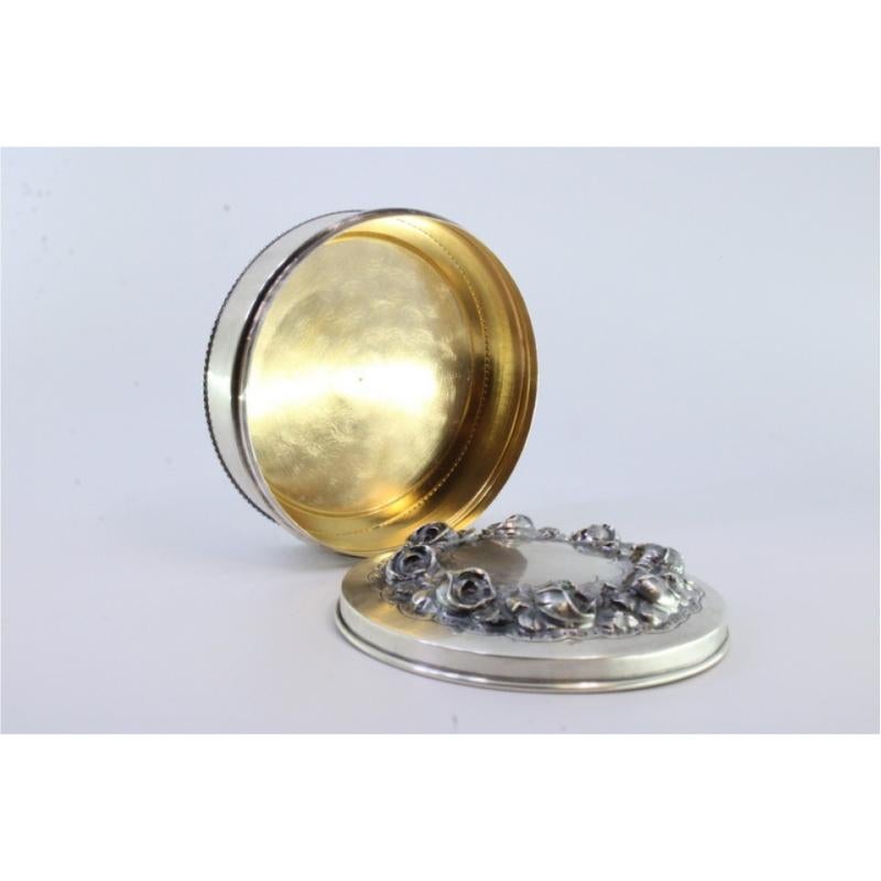 European Silver box w/ raised floral motifs & a surrounding frieze on the circular base For Sale
