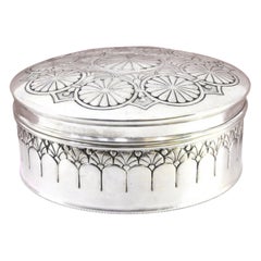 Silver box with concentric circles revealed on the removable lid
