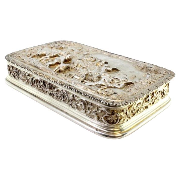 Silver box with country motifs and castle, frieze on lid and garlands