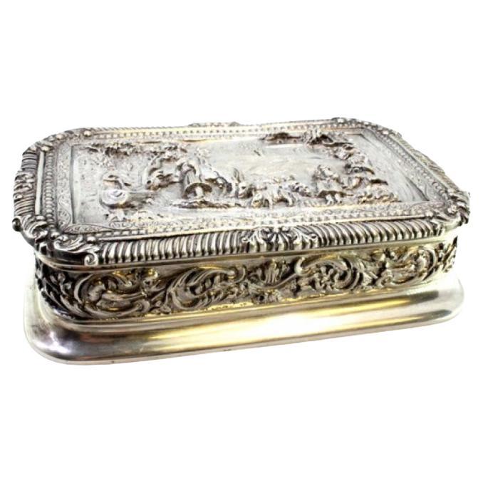 Silver box with country motifs, frieze on lid and garlands