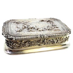 Silver box with country motifs, frieze on lid and garlands